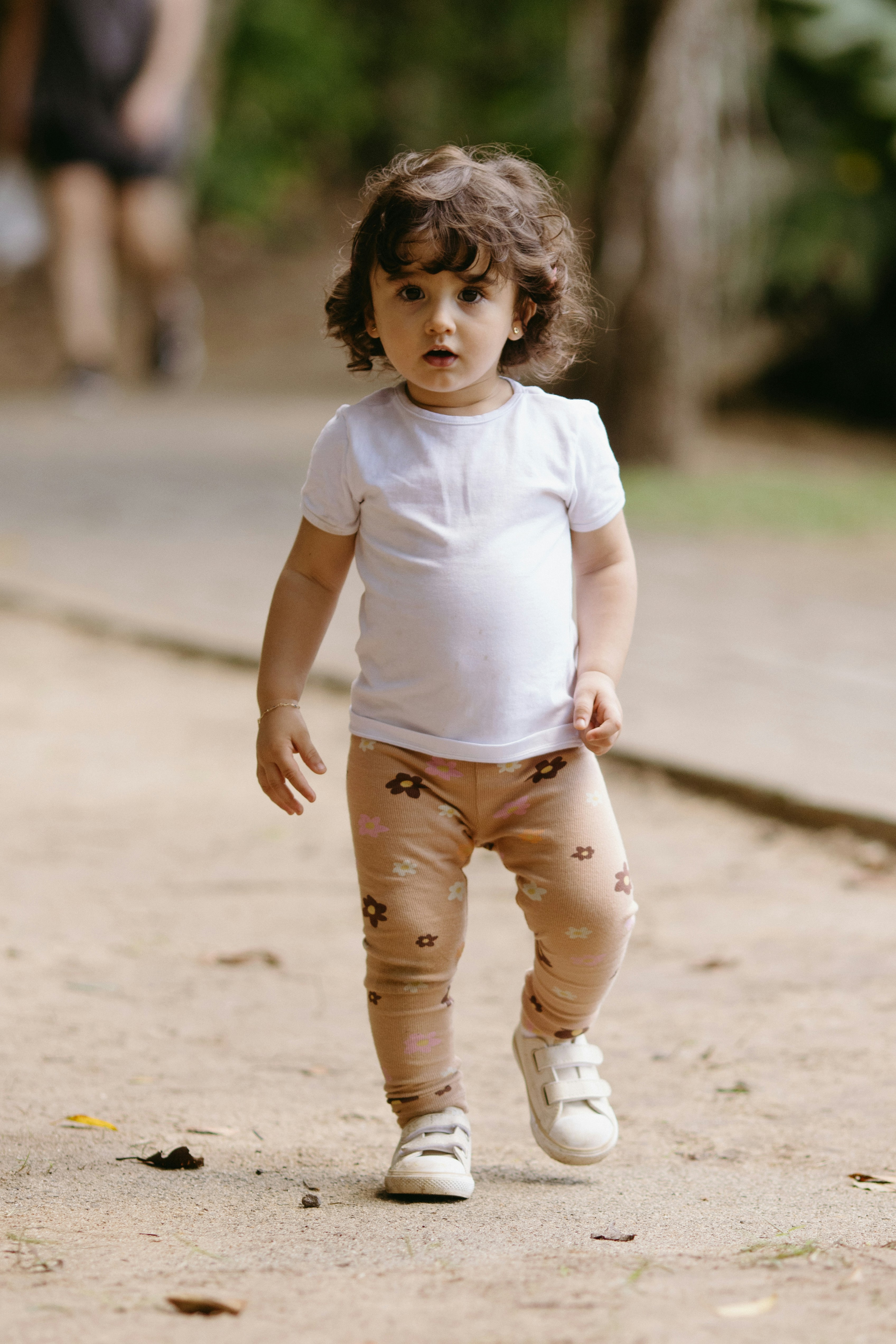 Original photo of a toddler walking outdoors